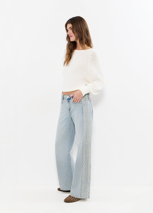 Jeans pieza lateral punto cruz