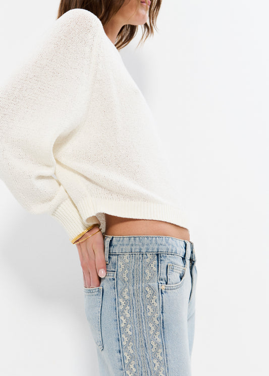 Jeans pieza lateral punto cruz